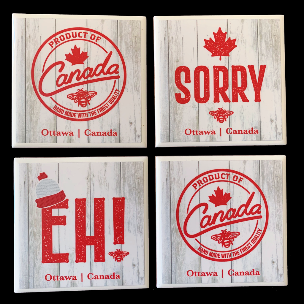 This set of four ceramic coasters features three Canadian sayings printed in red on a grey background. One coaster says “sorry” and has a red maple leaf printed above it. One coaster says “Eh!” It has a small toque printed on it. The last two coasters say “product of Canada, handmade with the finest quality”. The words are enclosed by a red ring which makes them look like a stamp or logo. At the bottom of the coasters the words “Ottawa Canada” are written in red text. 