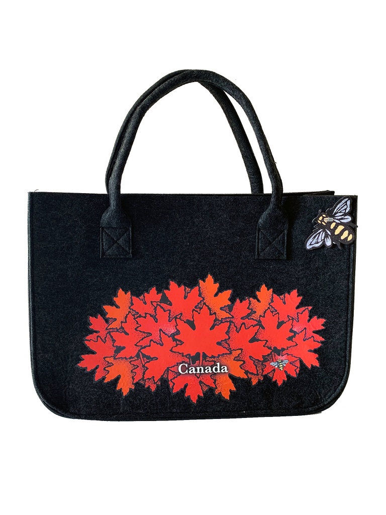 A stylish large charcoal tote bag with a group of bright red maple leaves.