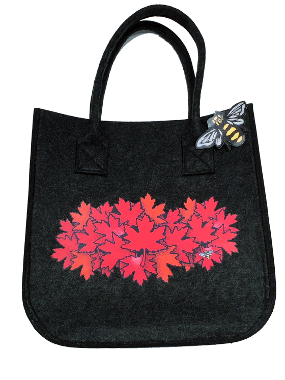 A stylish large charcoal tote bag with a group of bright red maple leaves.