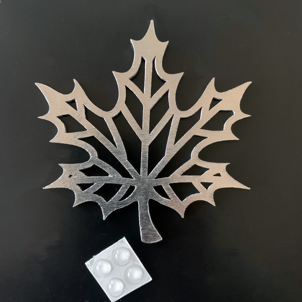 The maple leaf ornament as a coaster with four rubber dots that stick to the back to prevent slipping and scratching.