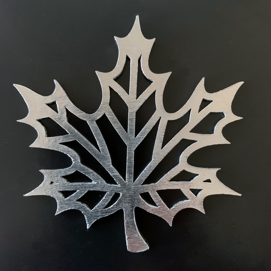 A maple leaf with lines where the leaf veins are, and hollow between the lines.