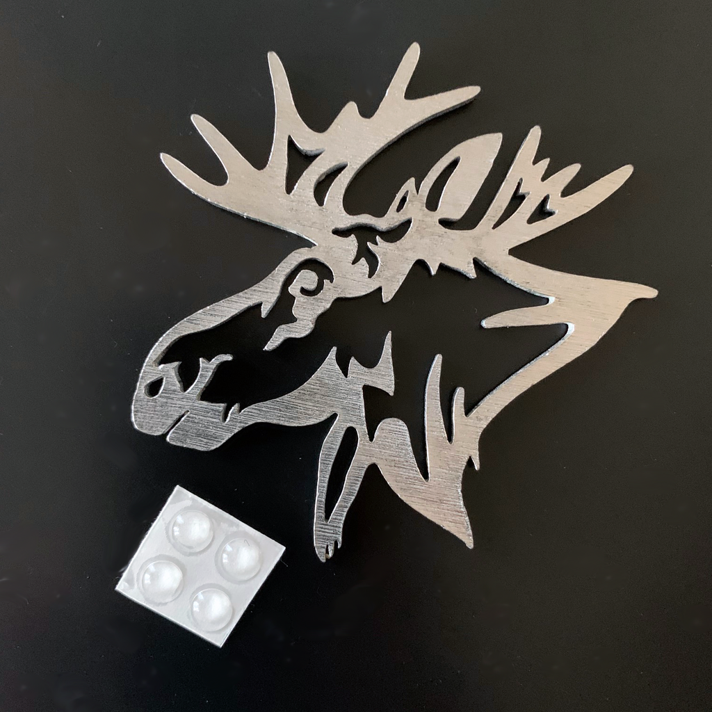The moose ornament as a coaster with four rubber dots that stick to the back to prevent slipping and scratching. 