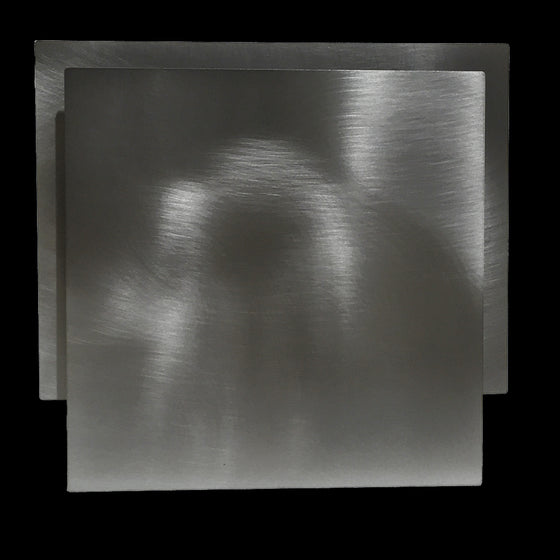 This frame consists of a square, with a rectangle offset upwards and 1/4" behind the square.  The surface of the steel frame is brushed, creating dazzling effects when lights shine on it.