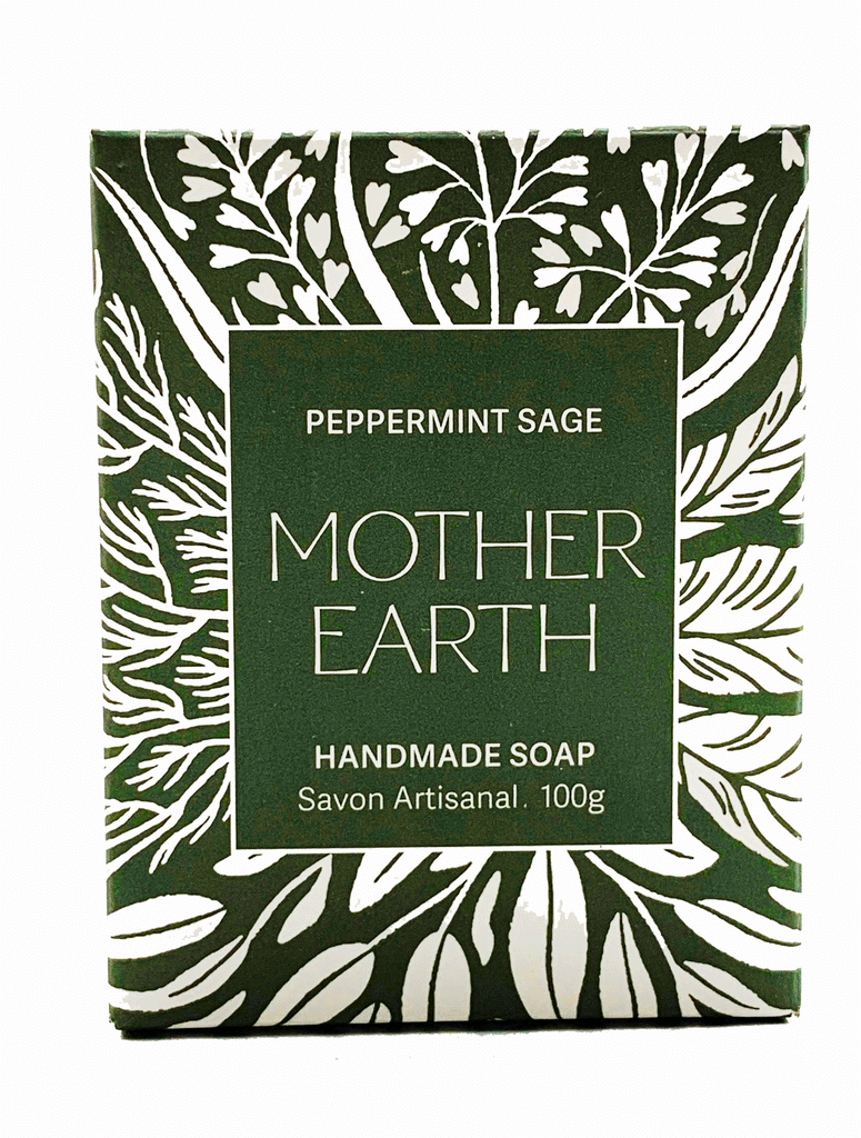 First Nation Green Bar of Soap inside a dark green carton box. Box has flowers in the background in white. In the middle, it is written 'Mother Earth' Handmade Soap. The scent of the Soap is Peppermint Sage.