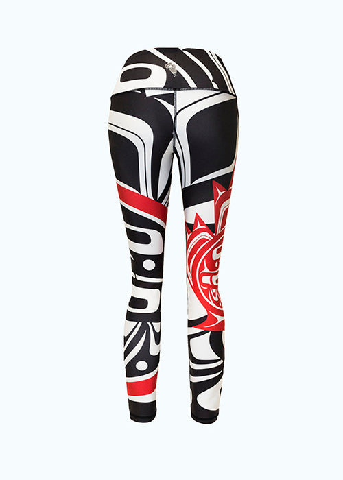 The eagle maple leaf leggings viewed from behind. Again, the large and small motifs can be seen. The white form lines of the larger motif contrast with the black background.