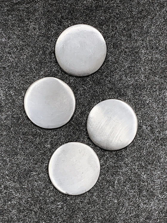 Four plain circular pewter magnets. 
