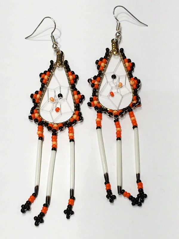 A pair of porcupine quill earrings. The hanging earrings are a tear drop shape hoop with dream catcher style weaving on the inside with black, orange, and pale orange beads woven into it. Black, orange, and pale orange beads are woven along the outside of the hoop and hanging off of the bottom are three strands with black, orange, and pale orange  beads, then a piece of porcupine quill, with more black and orange beads at the end.