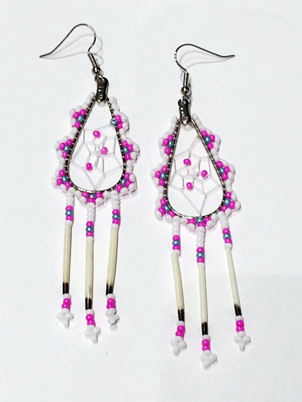 A pair of porcupine quill earrings. The hanging earrings are a tear drop shape hoop with dream catcher style weaving on the inside, with pink beads woven into it. Pink, blue, and white beads are woven along the outside of the hoop and hanging off of the bottom are three strands with white, pink, and blue beads, then a piece of porcupine quill, with more pink and white beads at the end.