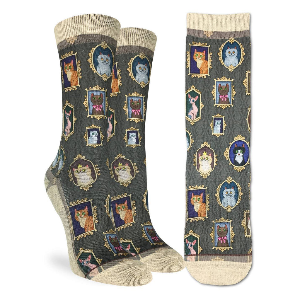 These fun socks feature framed pictures of cats of all shapes and colours hanging on a grey patterned wallpaper. The sole, toe, heel, and rim of the socks are a pale cream colour. The active fit socks sport elastic arch bands to contour to your feet and provide support. 
