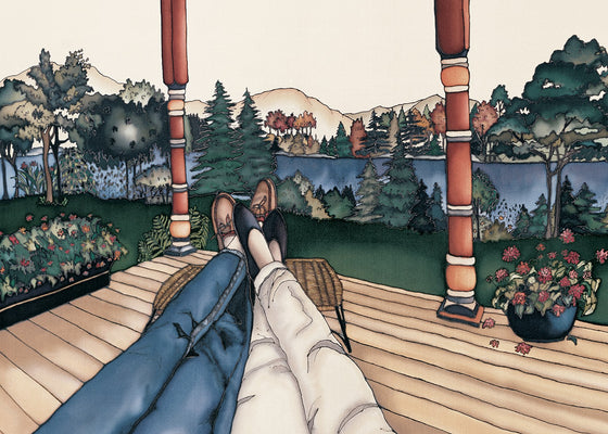 This rectangular magnet shows two pairs of legs with their feet resting on a stool as if two people are reclining next to each other. They are resting on a wooden deck by a river. The picture is richly coloured.