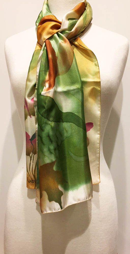 Pictured here is a green/gold/rust hand-painted silk scarf featuring several Canadian maple leaves of various sizes.