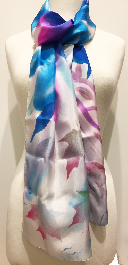Pictured here is a royal blue/pink/white hand-painted silk scarf featuring several Canadian maple leaves of various sizes.