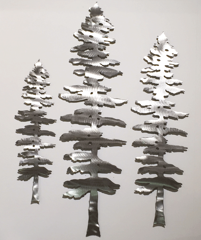 Three brushed metal Sitka pine sculptures. The metal has a bright, sparkling finish.