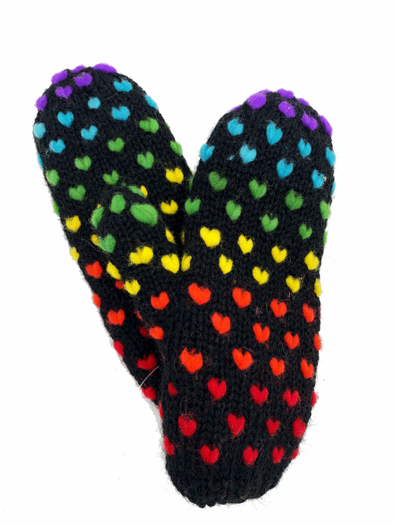 A black pair of knit mittens with small colourful hearts. Colours consist of red, orange, yellow, green, blue, and purple.